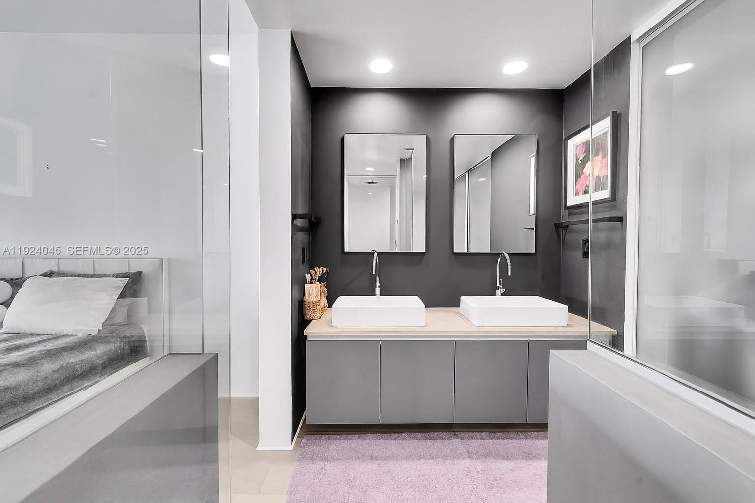 1040 Biscayne Boulevard, Unit 2603 Miami, FL 33132 - Photo 17 of 40 a bathroom with a double vanity sink a mirror and a bathtub