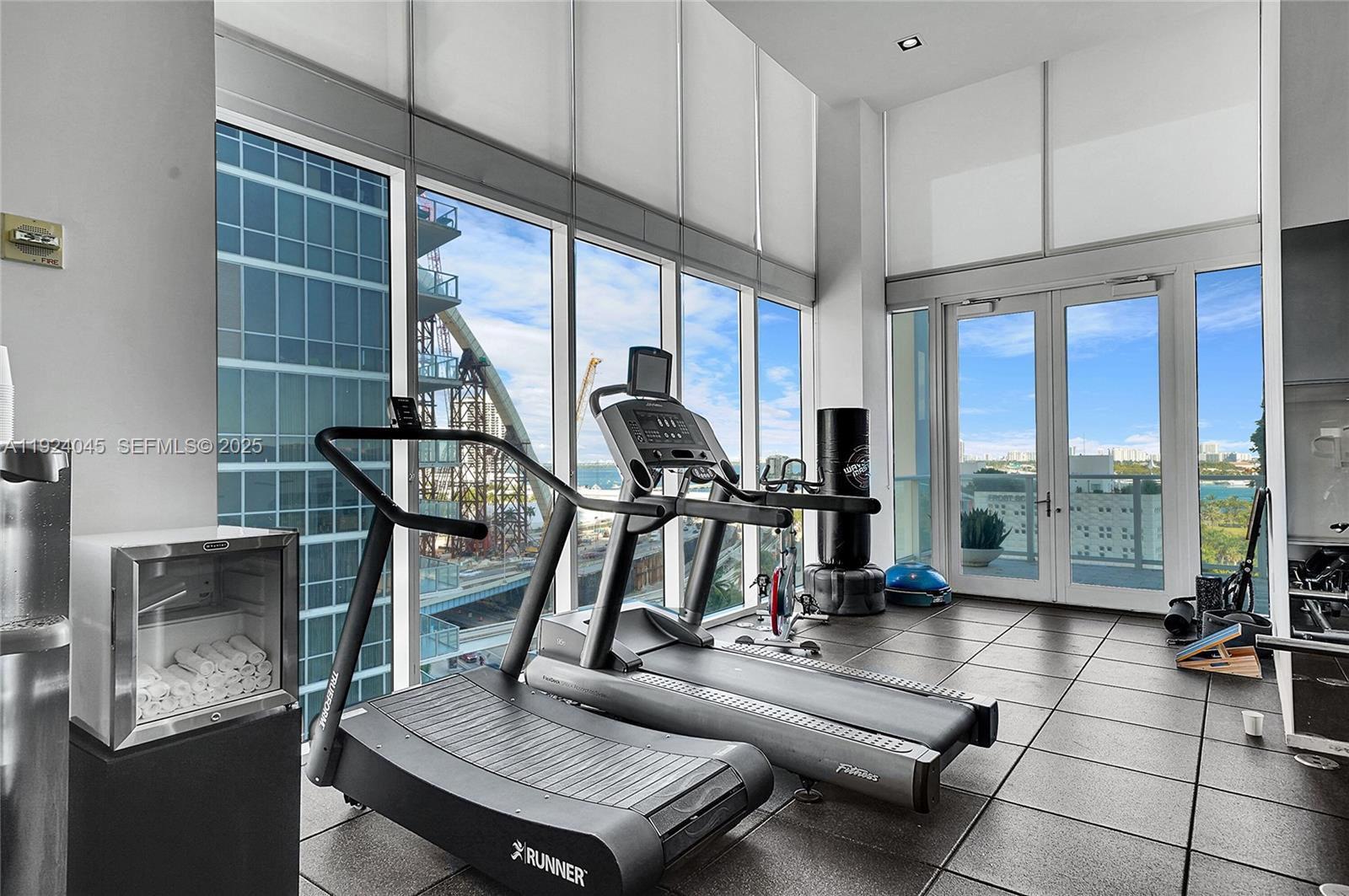1040 Biscayne Boulevard, Unit 2603 Miami, FL 33132 - Photo 32 of 40 a room with gym equipment and large windows