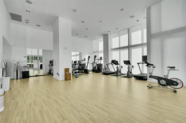 a view of a room with gym equipment and a large window