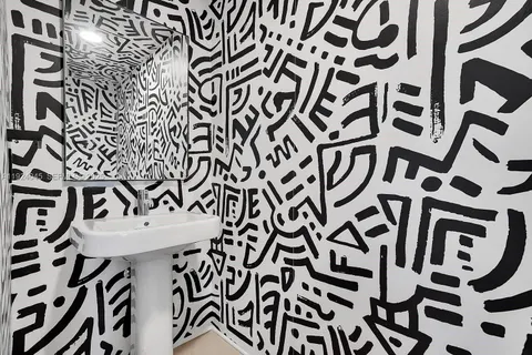 a view of a door and chair in the kitchen