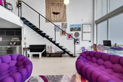 a livingroom with furniture and a flat screen tv