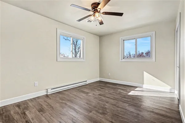 a view of an empty room with wooden floor
