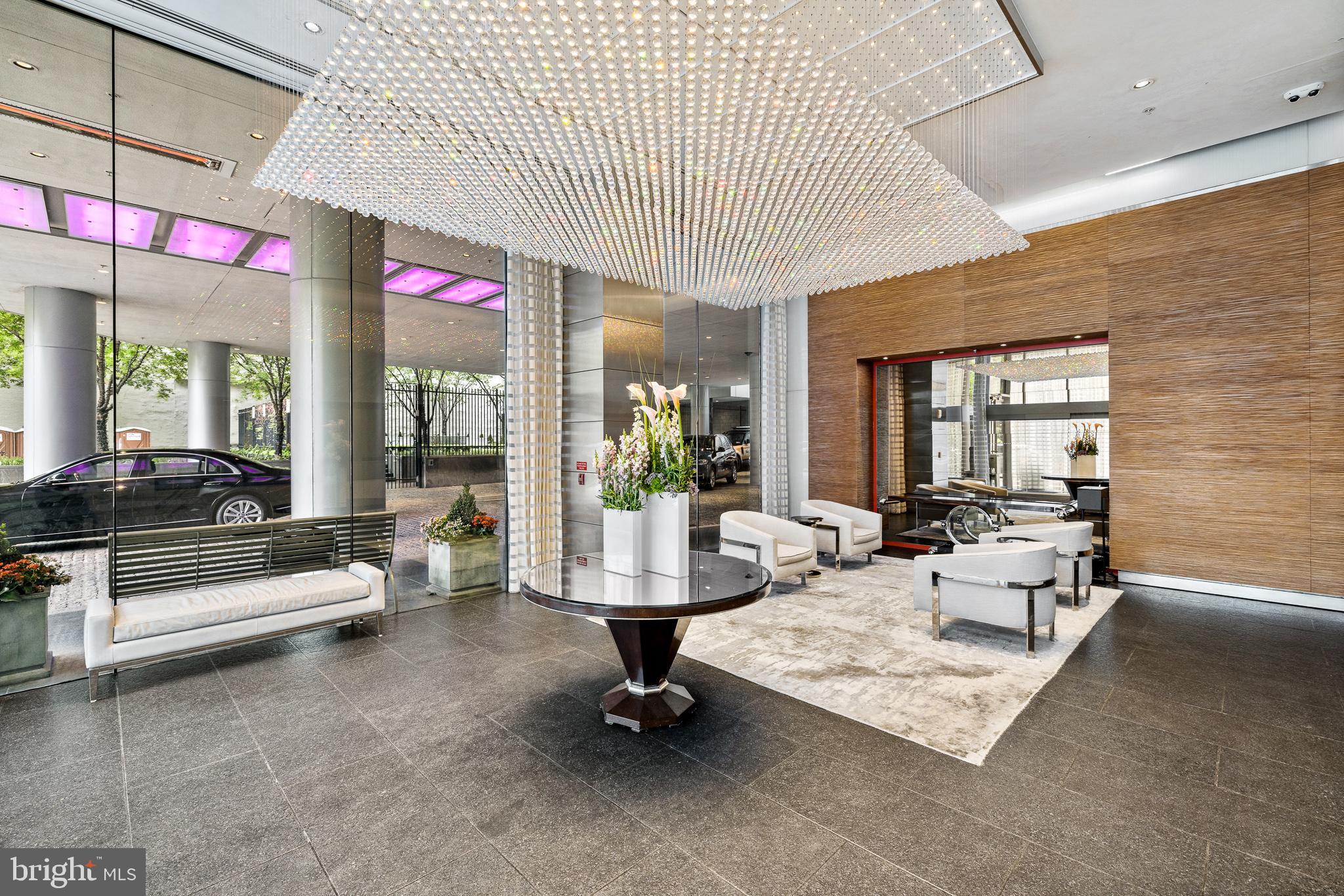 1414 South Penn Square, Unit PH1C Philadelphia, PA 19102 - Photo 9 of 19 a living room with furniture gym equipment and large windows
