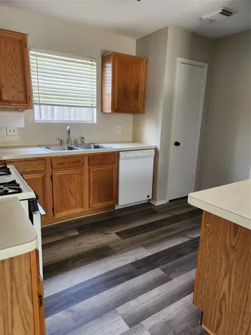 a kitchen with sink and cabinets