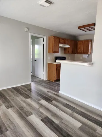 a kitchen with a refrigerator and a stove top oven