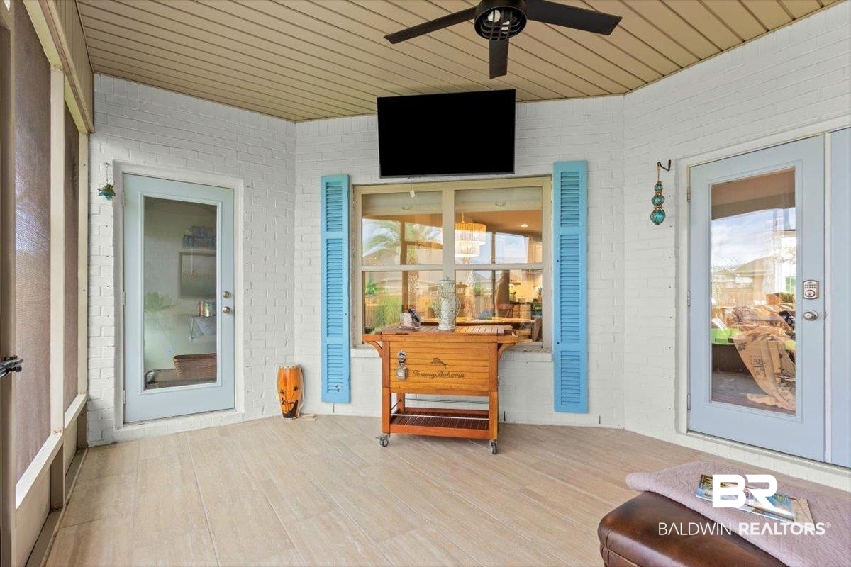 7056 Rocky Rd Loop Gulf Shores, AL 36542 - Photo 30 of 41 View of exterior entry with brick siding and a ceiling fan