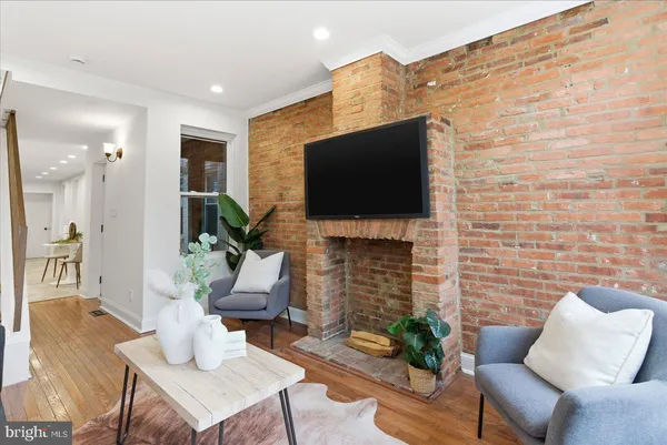 a living room with fireplace furniture and a flat screen tv
