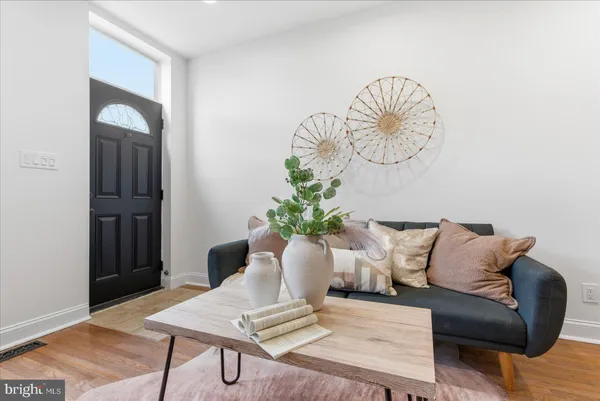 a living room with furniture and a potted plant
