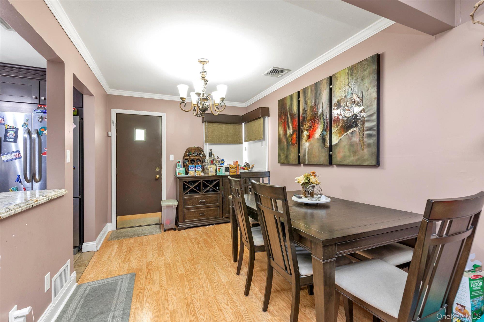 16 Layton Street Freeport, NY 11520 - Photo 4 of 17 a view of a dining room with furniture and a chandelier