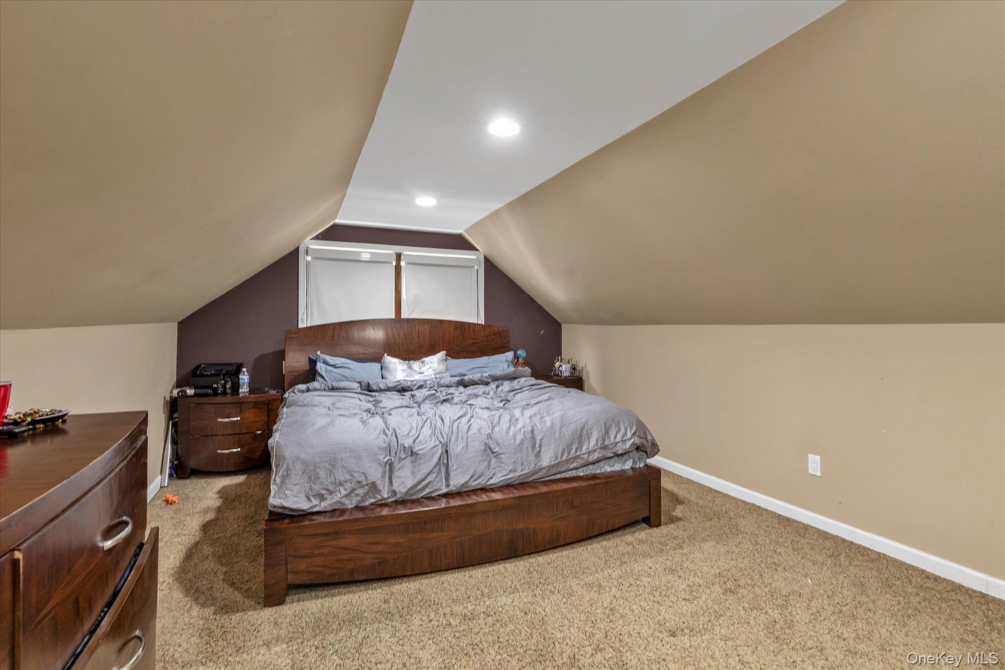 16 Layton Street Freeport, NY 11520 - Photo 9 of 17 a spacious bedroom with a bed and window