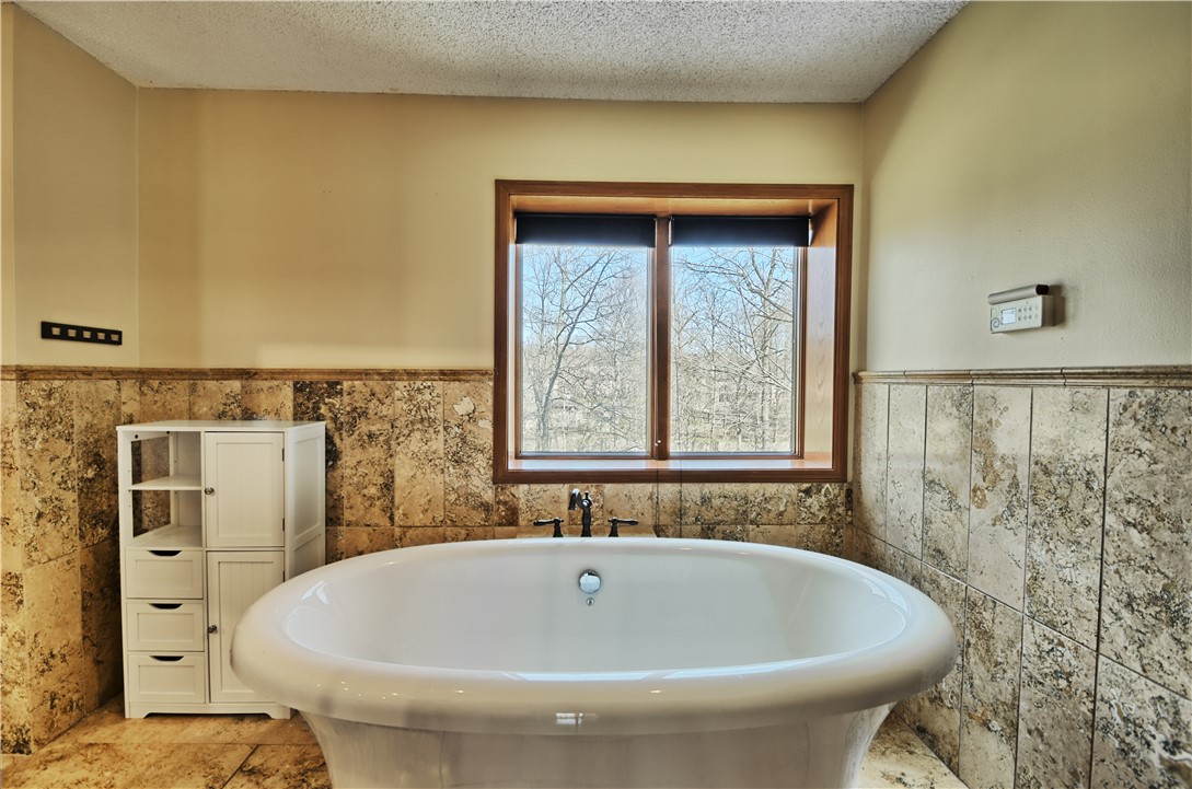 8711 Nicole Lane Springboro, OH 45066 - Photo 42 of 87 This serene bathroom offers a luxurious soaking tub with a beautiful view.