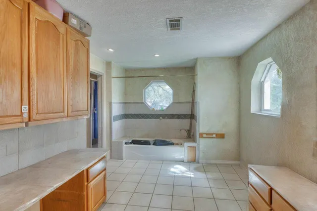 a bathroom with a toilet a sink and shower curtain
