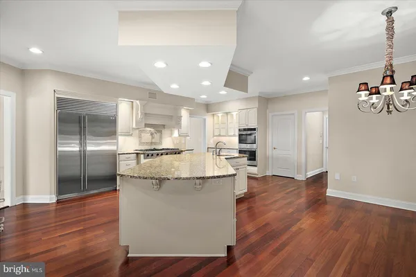 a view of a kitchen with furniture and wooden floor