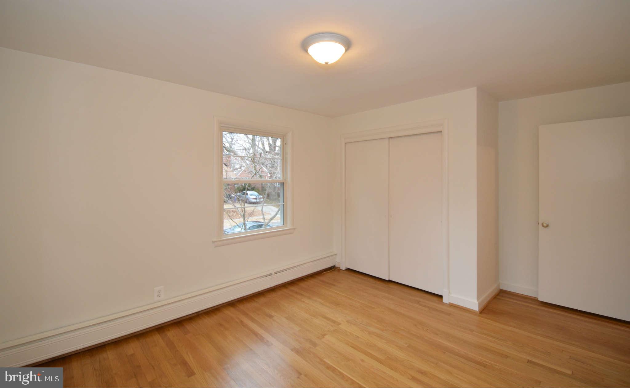 10107 Portland Place Silver Spring, MD 20901 - Photo 14 of 17 an empty room with wooden floor and windows