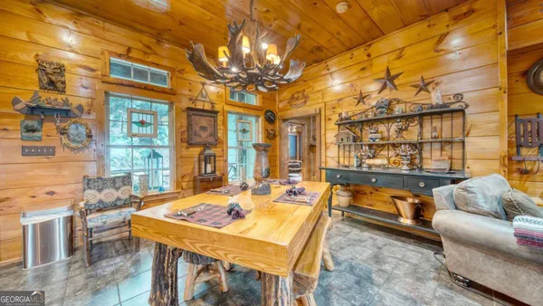 a dining room with furniture and a chandelier