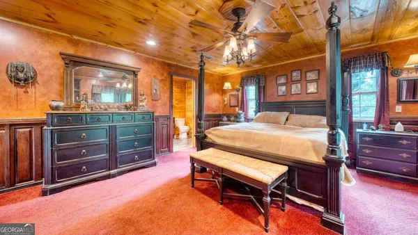 a bedroom with a bed and wooden cabinets