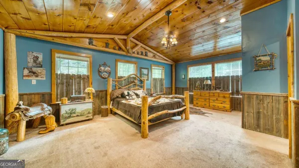 a bedroom with furniture and large window