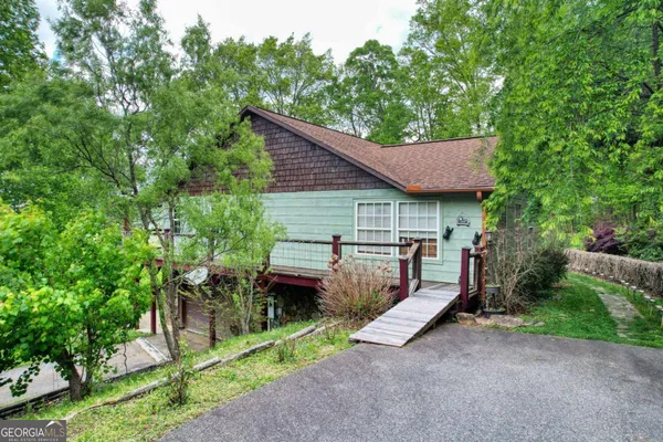 a view of a house with a yard and sitting area