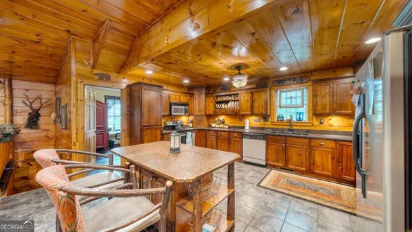 a large kitchen with a table and chairs