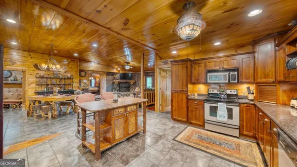 a kitchen with stainless steel appliances granite countertop a sink and cabinets