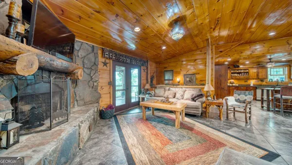 a living room with patio furniture and a fireplace