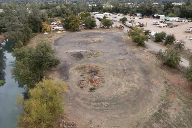 a view of a dirt road with a building in the background