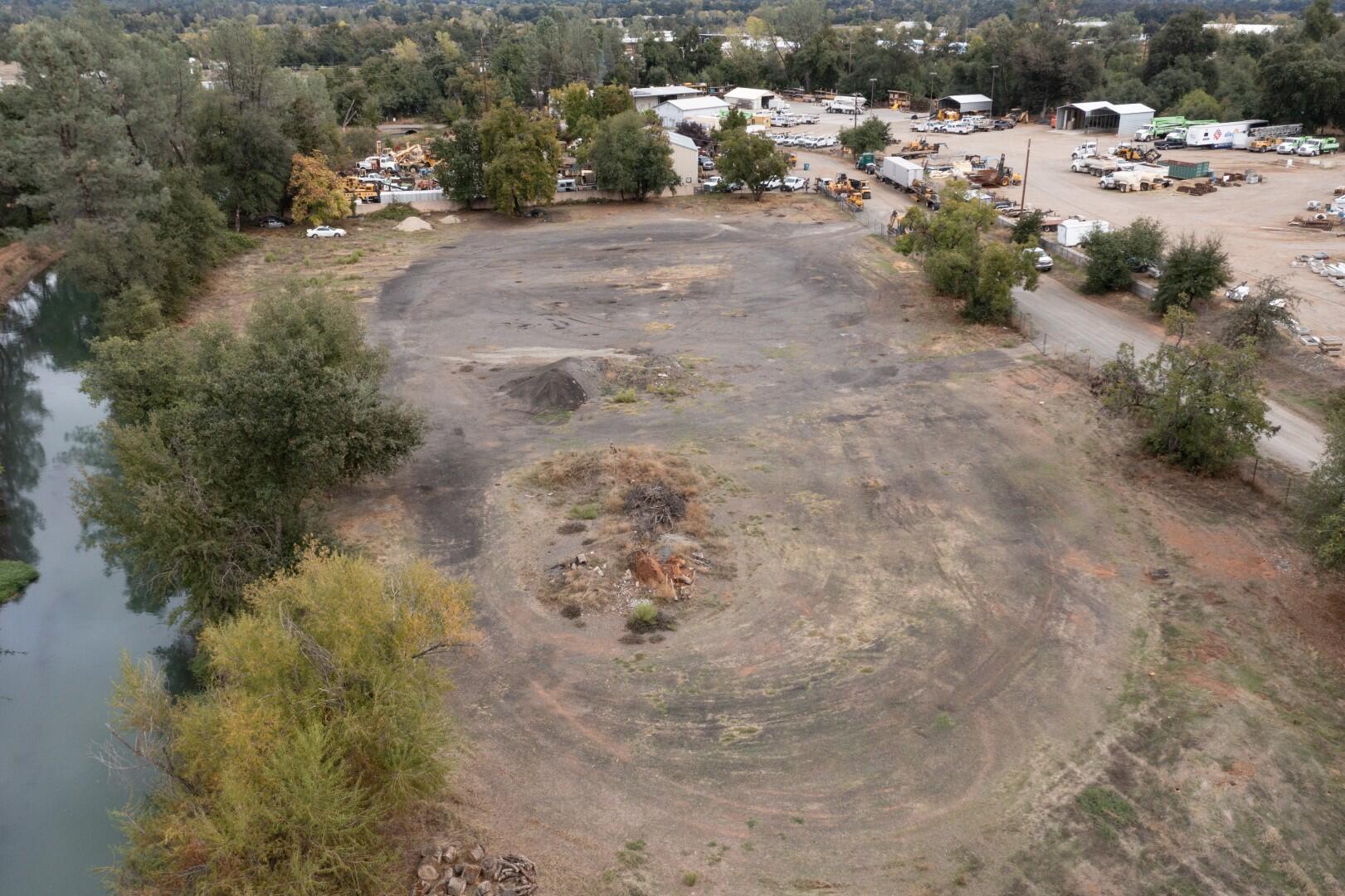 a view of a dirt road with a building in the background