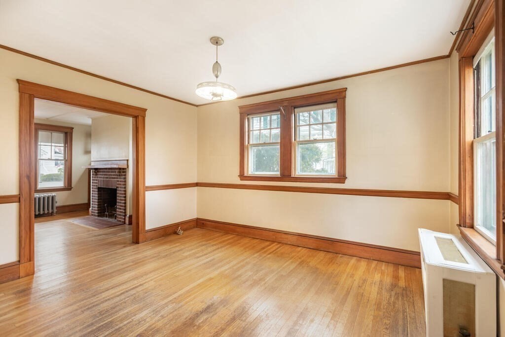 145 Robbins Road Arlington, MA 02476 - Photo 11 of 31 a view of an empty room with wooden floor and a window