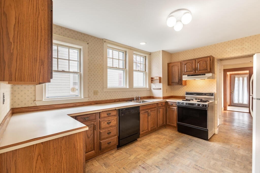 145 Robbins Road Arlington, MA 02476 - Photo 12 of 31 a kitchen with stainless steel appliances granite countertop a stove and a sink