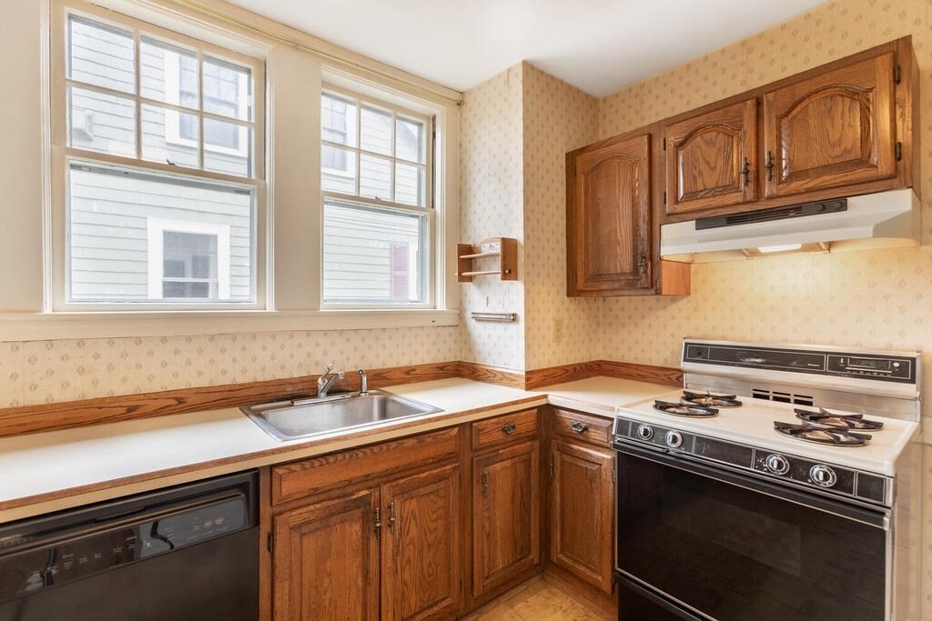 145 Robbins Road Arlington, MA 02476 - Photo 14 of 31 a kitchen with stainless steel appliances granite countertop a sink stove and cabinets