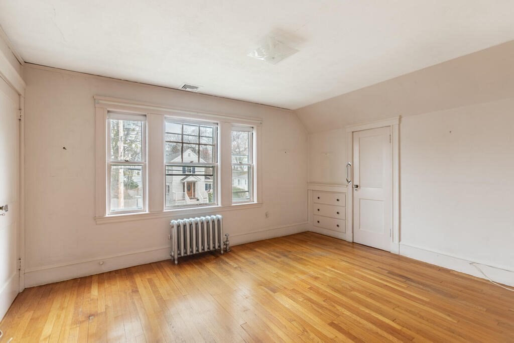 145 Robbins Road Arlington, MA 02476 - Photo 22 of 31 an empty room with wooden floor and windows