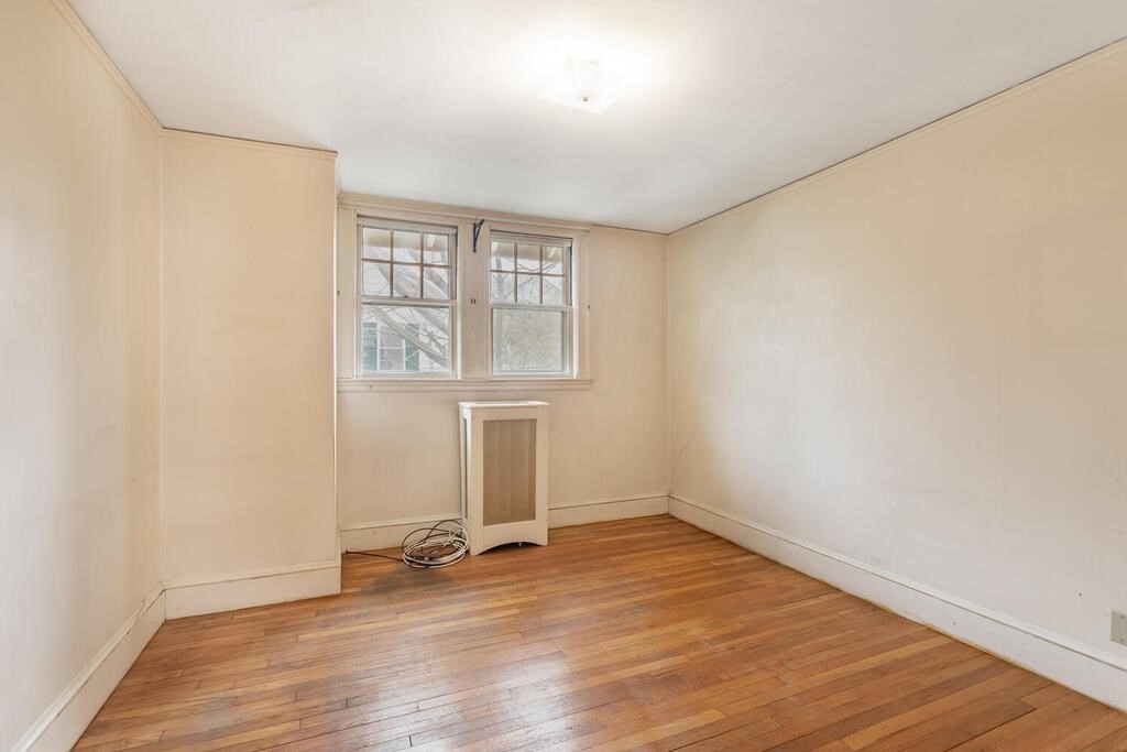 145 Robbins Road Arlington, MA 02476 - Photo 24 of 31 an empty room with wooden floor and windows
