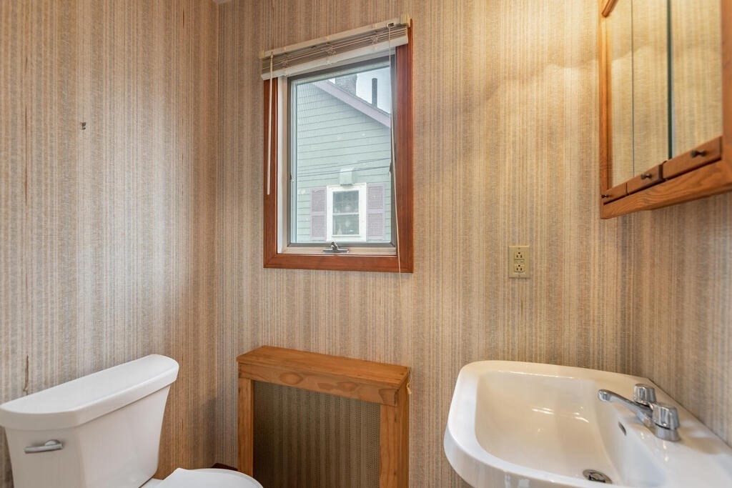145 Robbins Road Arlington, MA 02476 - Photo 27 of 31 a bathroom with a sink a toilet and a mirror