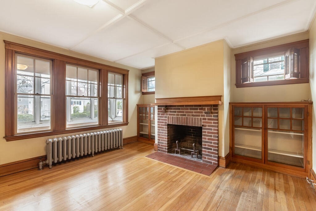 145 Robbins Road Arlington, MA 02476 - Photo 6 of 31 wooden floor fireplace and windows in an empty room