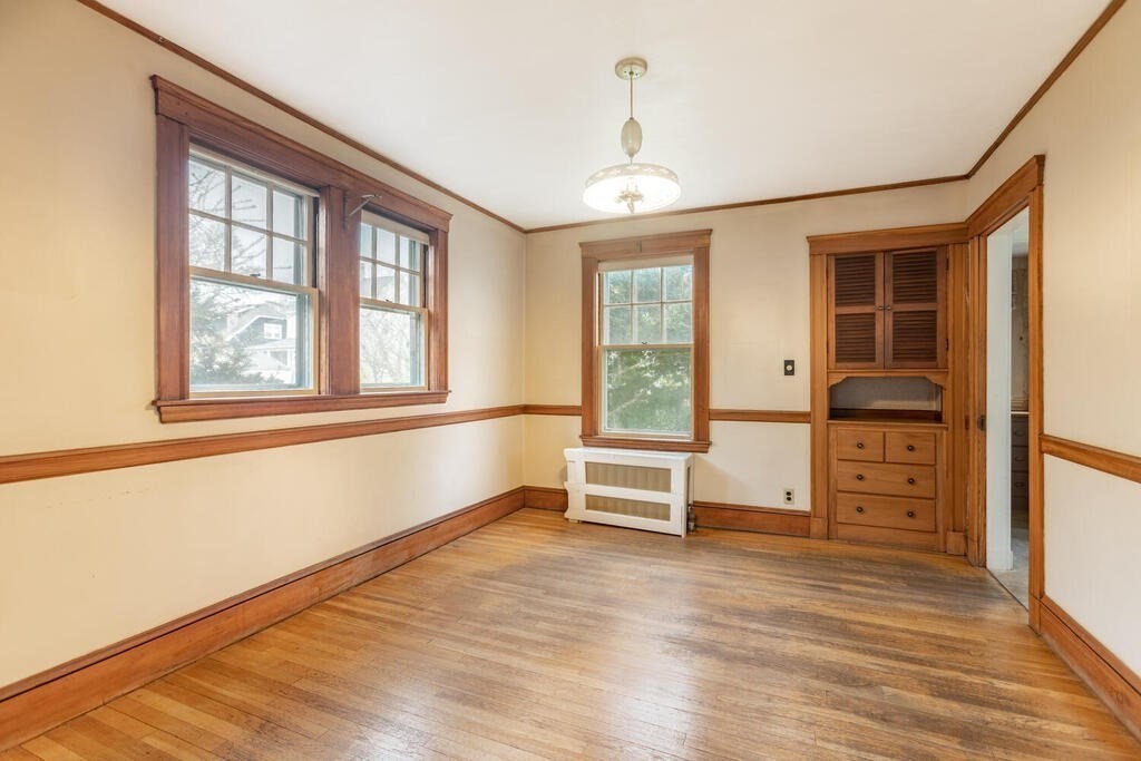 145 Robbins Road Arlington, MA 02476 - Photo 9 of 31 a view of a bedroom with furniture and windows
