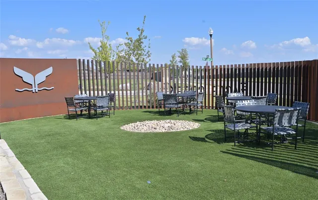 a view of a chair and table in the garden