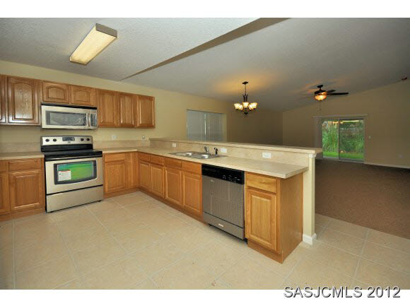 171 Blocker Street St. Augustine, FL 32084 - Photo 4 of 13 a kitchen with a sink stove and cabinets