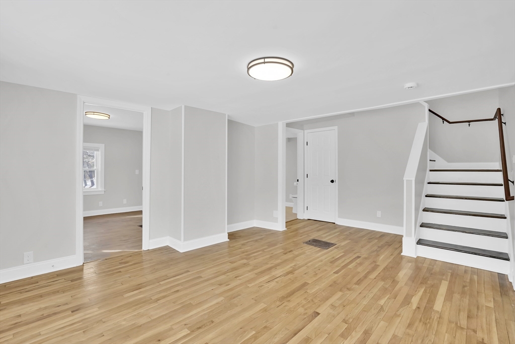 273 Dunhamtown Palmer Road Brimfield, MA 01010 - Photo 11 of 42 an empty room with wooden floor and entryway