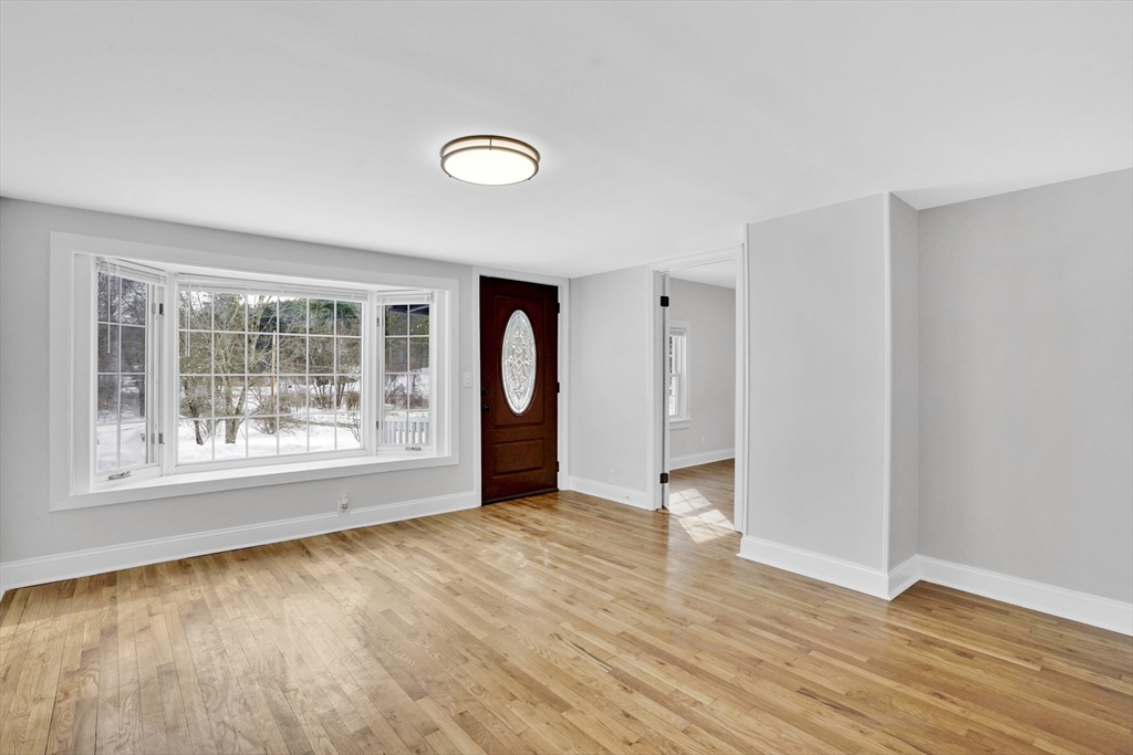 273 Dunhamtown Palmer Road Brimfield, MA 01010 - Photo 12 of 42 an empty room with wooden floor and a window