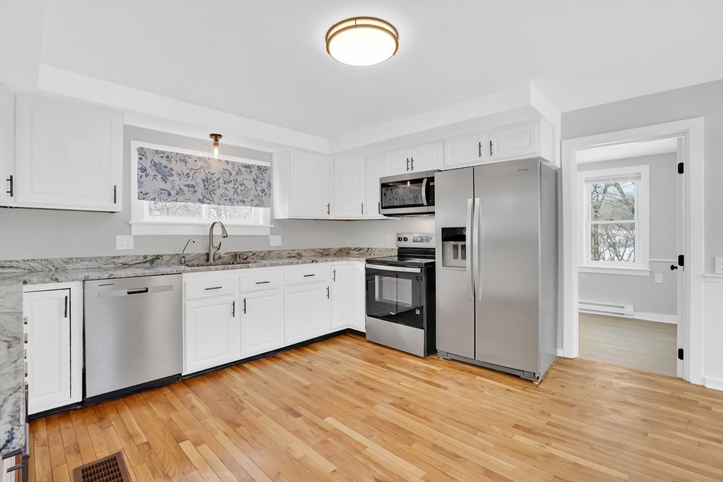 273 Dunhamtown Palmer Road Brimfield, MA 01010 - Photo 22 of 42 a kitchen with granite countertop a refrigerator and a sink