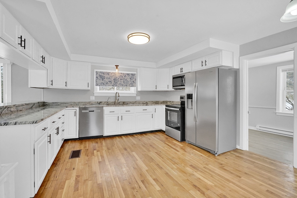 273 Dunhamtown Palmer Road Brimfield, MA 01010 - Photo 23 of 42 a kitchen with stainless steel appliances granite countertop a refrigerator sink and white cabinets