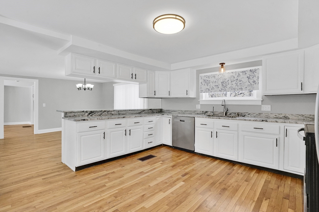 273 Dunhamtown Palmer Road Brimfield, MA 01010 - Photo 24 of 42 a kitchen with granite countertop white cabinets and white stainless steel appliances
