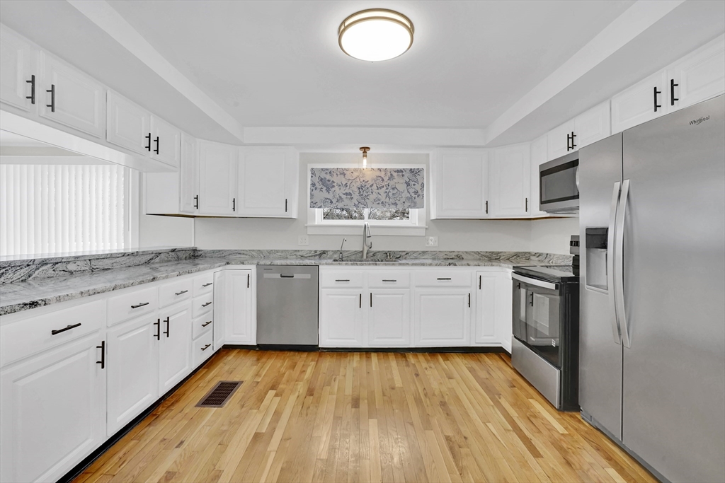 273 Dunhamtown Palmer Road Brimfield, MA 01010 - Photo 27 of 42 a kitchen with granite countertop white cabinets and stainless steel appliances