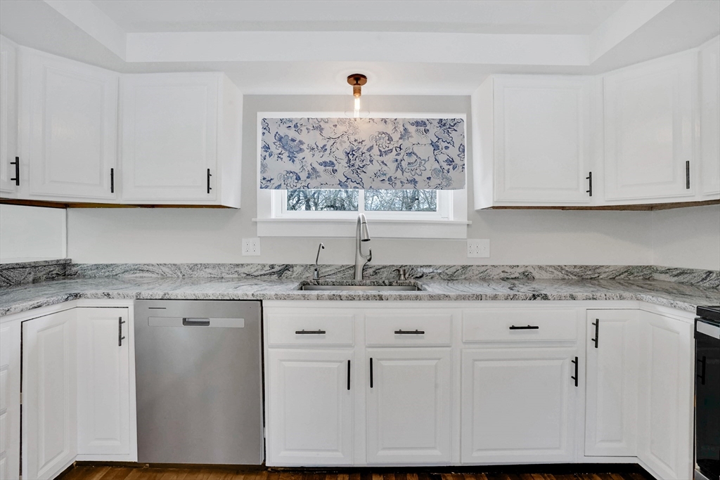 273 Dunhamtown Palmer Road Brimfield, MA 01010 - Photo 28 of 42 a kitchen with granite countertop white cabinets and a window