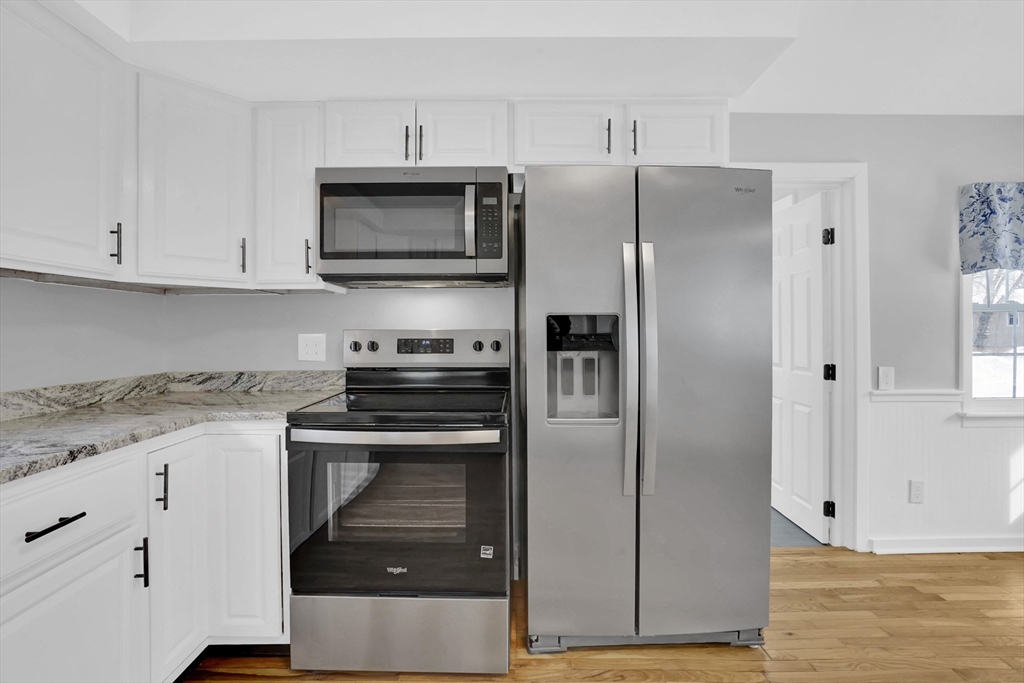 273 Dunhamtown Palmer Road Brimfield, MA 01010 - Photo 29 of 42 a kitchen with granite countertop a refrigerator and a stove