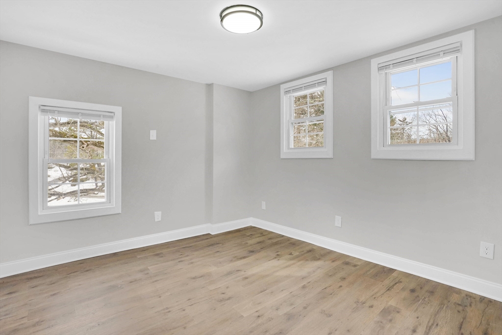 273 Dunhamtown Palmer Road Brimfield, MA 01010 - Photo 34 of 42 a view of an empty room with a window and wooden floor