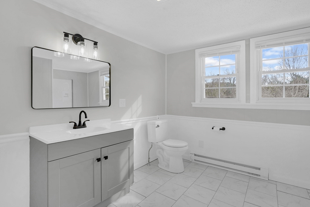 273 Dunhamtown Palmer Road Brimfield, MA 01010 - Photo 38 of 42 a bathroom with a toilet sink and mirror