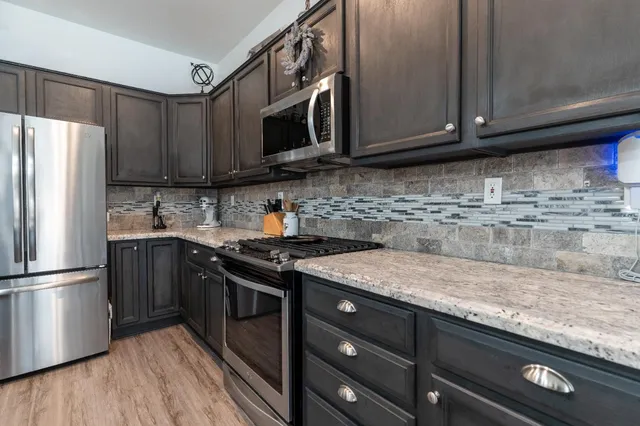 a kitchen with granite countertop a stove and a sink