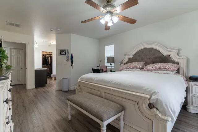 a bedroom with a large bed and a window