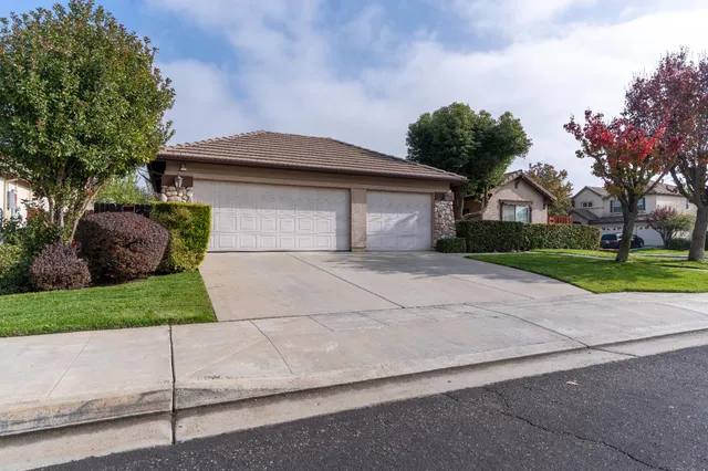 a front view of a house with a yard and a garage